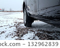 Snow in tire tread blocks at the car at snowy country road Snow in tire tread blocks at the car at snowy country road 132962839