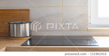 Pot near window in kitchen. Morning clarity, light, and calm rhythm of home routine. Banner copy space and empty place for advertising. Pot near window in kitchen. Morning clarity, light, and calm rhythm of home routine. Banner copy space and empty place for advertising. 132962918