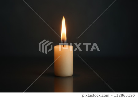 Single Burning Candle On Dark Background With Reflection, Warm Peaceful Glow 132963150