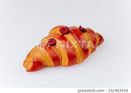 Elegant croissant with red glaze and dried berries isolated on white, gourmet bakery pastry Elegant croissant with red glaze and dried berries isolated on white, gourmet bakery pastry 132963429
