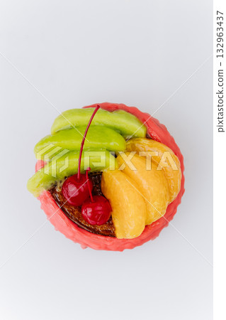 Colorful fruit pastry with red glaze, kiwi, tangerine, and cherries on white background Colorful fruit pastry with red glaze, kiwi, tangerine, and cherries on white background 132963437