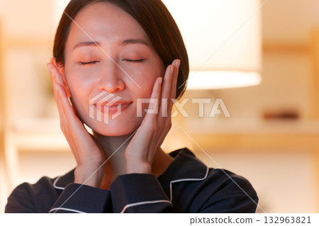 A woman who feels moisturized skin A woman who feels moisturized skin 132963821