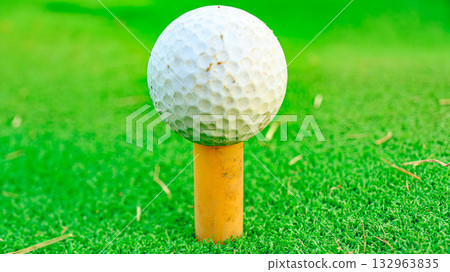 Golf ball on a rubber tee Golf ball on a rubber tee 132963835