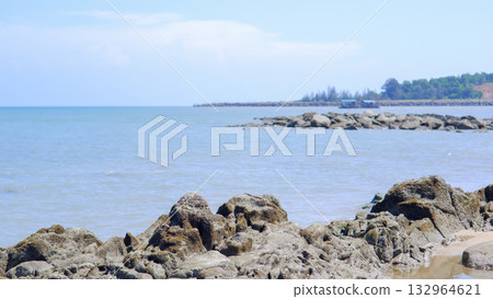 Jagged Rocks in Foreground on a Beach with Rocky Groynes Extending to the Horizon Jagged Rocks in Foreground on a Beach with Rocky Groynes Extending to the Horizon 132964621