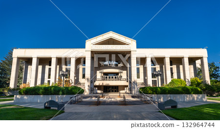 The front facade of the Supreme Court of Nevada in Carson City. The symmetrical architecture is lit by sun under a deep blue sky. Represents law, justice, and state government 132964744