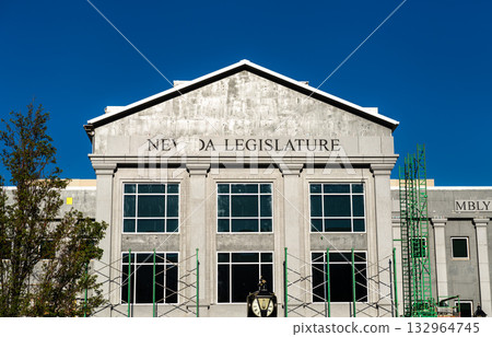The Nevada Legislature building in Carson City during construction. Scaffolding is visible on the unfinished facade against a clear blue sky. Represents government and development The Nevada Legislature building in Carson City during construction. Scaffolding is visible on the unfinished facade against a clear blue sky. Represents government and development 132964745