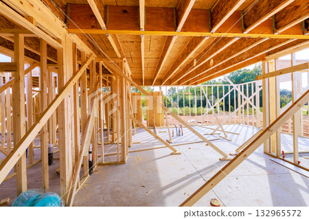 Wooden structures are being erected frame beams at construction site 132965572