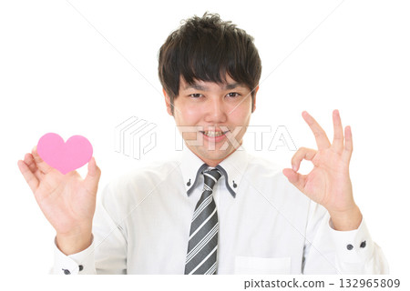 A man holding a heart-shaped object A man holding a heart-shaped object 132965809