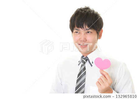 A man holding a heart-shaped object A man holding a heart-shaped object 132965810