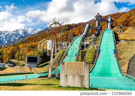 Hakuba Ski Jump Stadium and the mountains with autumn leaves 132966080