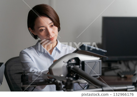 A person who inspects and maintains drones A person who inspects and maintains drones 132966176