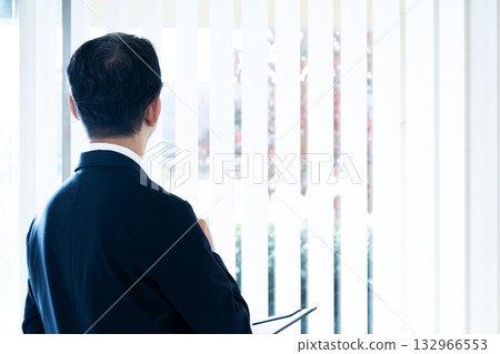 Businessman looking outside Businessman looking outside 132966553