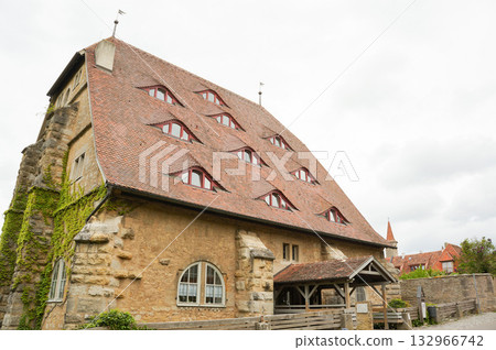 A building with a roof covered with many windows near the German tourist destination of Rothenburg A building with a roof covered with many windows near the German tourist destination of Rothenburg 132966742
