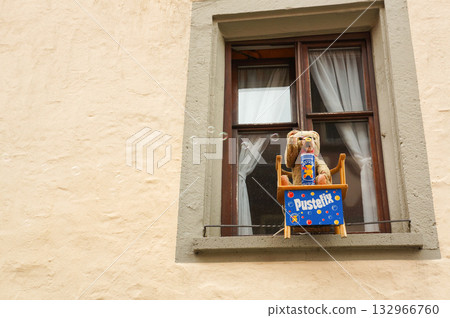 A bear doll blowing bubbles in the window of a building in Rothenburg A bear doll blowing bubbles in the window of a building in Rothenburg 132966760