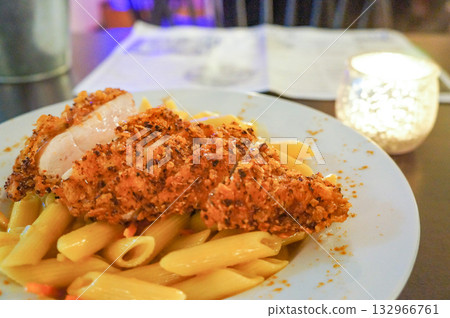 Pasta topped with crispy fried chicken Pasta topped with crispy fried chicken 132966761
