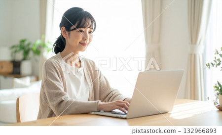 A middle-aged Japanese woman using a laptop at home for online business 16:9 size 132966893
