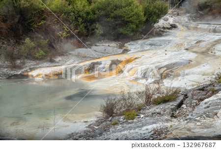 Limestone forms around hot springs in the form of travertine, a porous rock created by the rapid precipitation of calcium carbonate in Whakarewarewa the living Maori village in Rotorua, New Zealand. Limestone forms around hot springs in the form of travertine, a porous rock created by the rapid precipitation of calcium carbonate in Whakarewarewa the living Maori village in Rotorua, New Zealand. 132967687