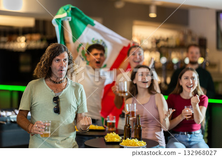 Group of friends cheer together for their favorite Mexican team in beer bar Group of friends cheer together for their favorite Mexican team in beer bar 132968027