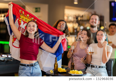 Group of fans in bar with Serbian flag Group of fans in bar with Serbian flag 132968036