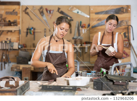 Girl is busy in carpentry workshop Girl is busy in carpentry workshop 132968206