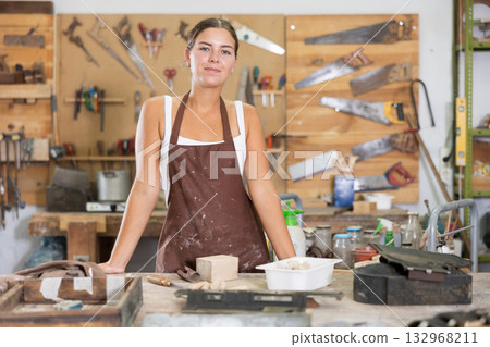 Young girl posing in taller workshop Young girl posing in taller workshop 132968211