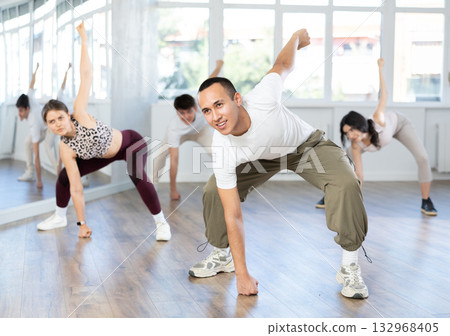 Young Asian dancer rehearsing krump dance moves in studio 132968405