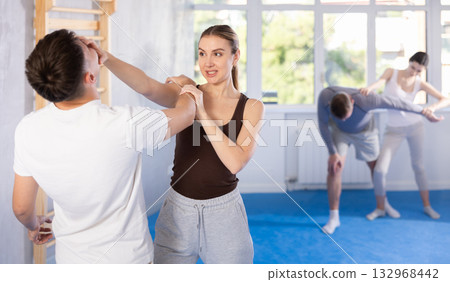 Woman hits man attacker on head during self-defense training session led by trainer Woman hits man attacker on head during self-defense training session led by trainer 132968442