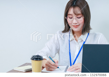 A young lady working on desk work A young lady working on desk work 132970066