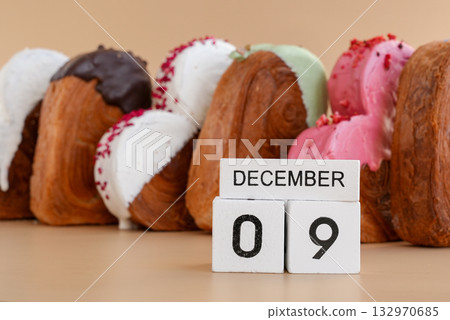 Calendar date 9 December National pastry day greeting card Delicious fresh croissant topped with colorful flavor Ganache. Creation unique heart shape bakery. Puff pastry holiday love gift present idea Calendar date 9 December National pastry day greeting card Delicious fresh croissant topped with colorful flavor Ganache. Creation unique heart shape bakery. Puff pastry holiday love gift present idea 132970685