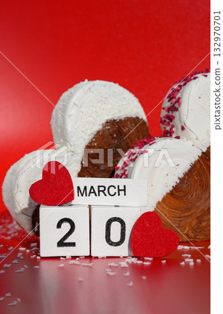 20 march International Day of Happiness Heart shaped coconut flavor croissant on red background with copy space. Puff pastry new trendy sweet dessert bakery. Creamy dough 20 march International Day of Happiness Heart shaped coconut flavor croissant on red background with copy space. Puff pastry new trendy sweet dessert bakery. Creamy dough 132970701