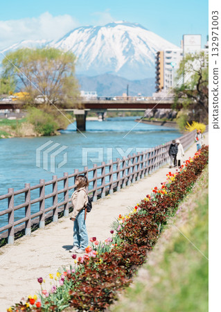 Woman tourist sightseeing Iwate mountain and Kitakami river with flowers in Spring, happy traveler travel in Morioka city, Iwate prefecture, Japan. famous Landmark Travel and Vacation destination 132971003