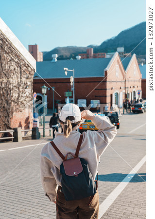 Woman tourist Visiting in Hakodate, happy Traveler sightseeing Kanemori Red Brick Warehouse in spring season. landmark and popular for attractions in Hokkaido, Japan. Travel and Vacation concept 132971027