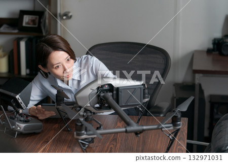 A woman performing drone maintenance 132971031
