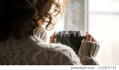 Woman enjoying a hot drink on a cold winter day. Woman enjoying a hot drink on a cold winter day. 132971731