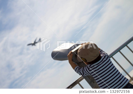 A boy watching planes at his favorite airport 132972556