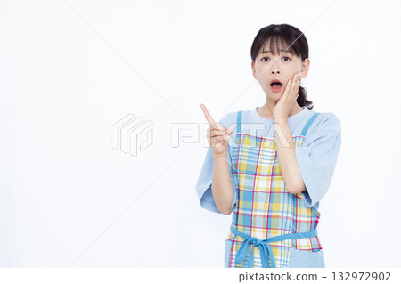 A housewife who is surprised and surprised with her index finger raised A housewife who is surprised and surprised with her index finger raised 132972902