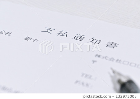 Close-up of a payment notice and pen 132973003