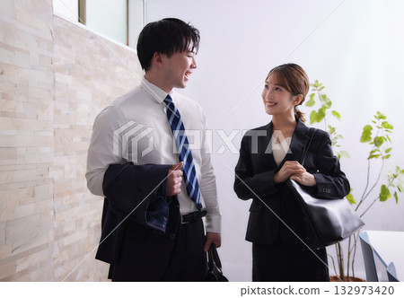 Young businessman and businesswoman going out on a business trip 132973420