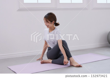 Young woman receiving training from a personal trainer Young woman receiving training from a personal trainer 132973421