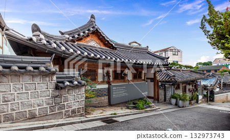 The exterior of a traditional Hanok building and stone wall at Bukchon Hanok Village, Seoul, a famous cultural travel landmark of South Korea 132973743