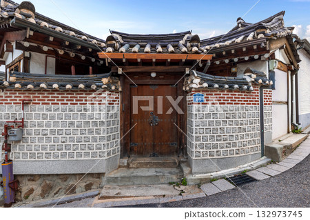 Traditional wooden door and entrance facade of a Hanok house within Bukchon Hanok Village, a famous cultural travel landmark 132973745
