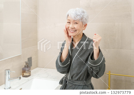 Senior woman in the bathroom (beauty and skin care) 132973779