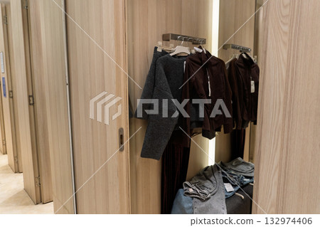 Clothes in a Fitting Room with Wooden Doors 132974406