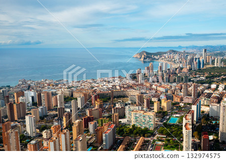Beautiful panoramic view of Benidorm city with its iconic skyline, tall buildings, and the endless Mediterranean horizon. A modern coastal metropolis on the Costa Blanca. Beautiful panoramic view of Benidorm city with its iconic skyline, tall buildings, and the endless Mediterranean horizon. A modern coastal metropolis on the Costa Blanca. 132974575