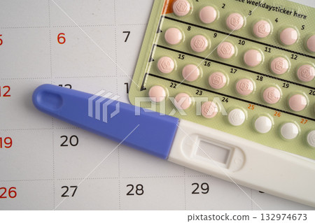 Pregnancy test and birth control pills on calendar, contraception health and medicine. Pregnancy test and birth control pills on calendar, contraception health and medicine. 132974673