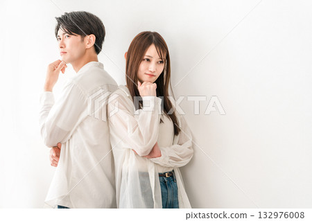 Young Asian couple standing back to back (worried, thinking, troubled, trouble) 132976008