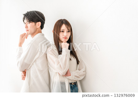 Young Asian couple standing back to back (worried, thinking, troubled, trouble) 132976009