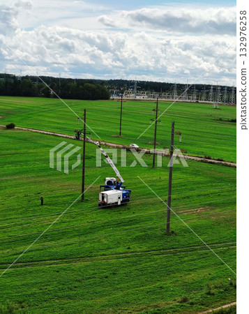 Aerial work platform truck repairing power lines. Aerial work platform truck repairing power lines. 132976258