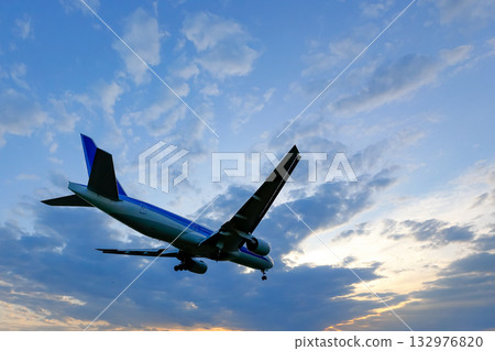 Sunset clouds | Landing plane | Backlit 132976820
