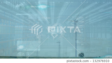 Standing tall wind turbine right in warehouse grassland with racks and digital overlays, copy space 132976910